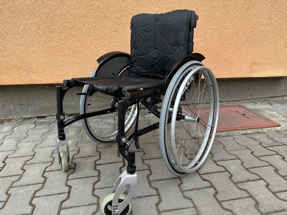 Invalidní vozík černý, nemá podnože, šířka sedu 43 cm