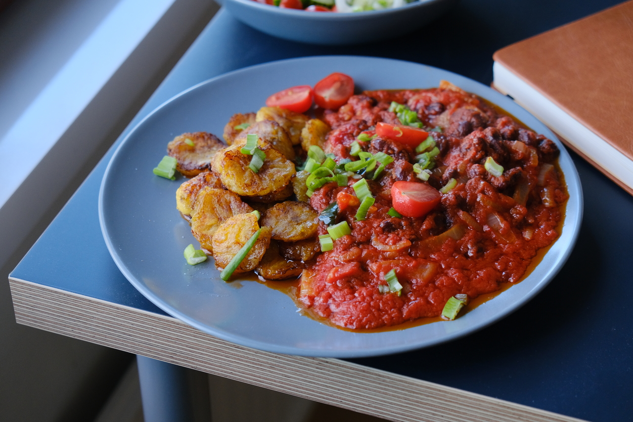 Ghanaian kelewele (fried plantain) with red red sauce.