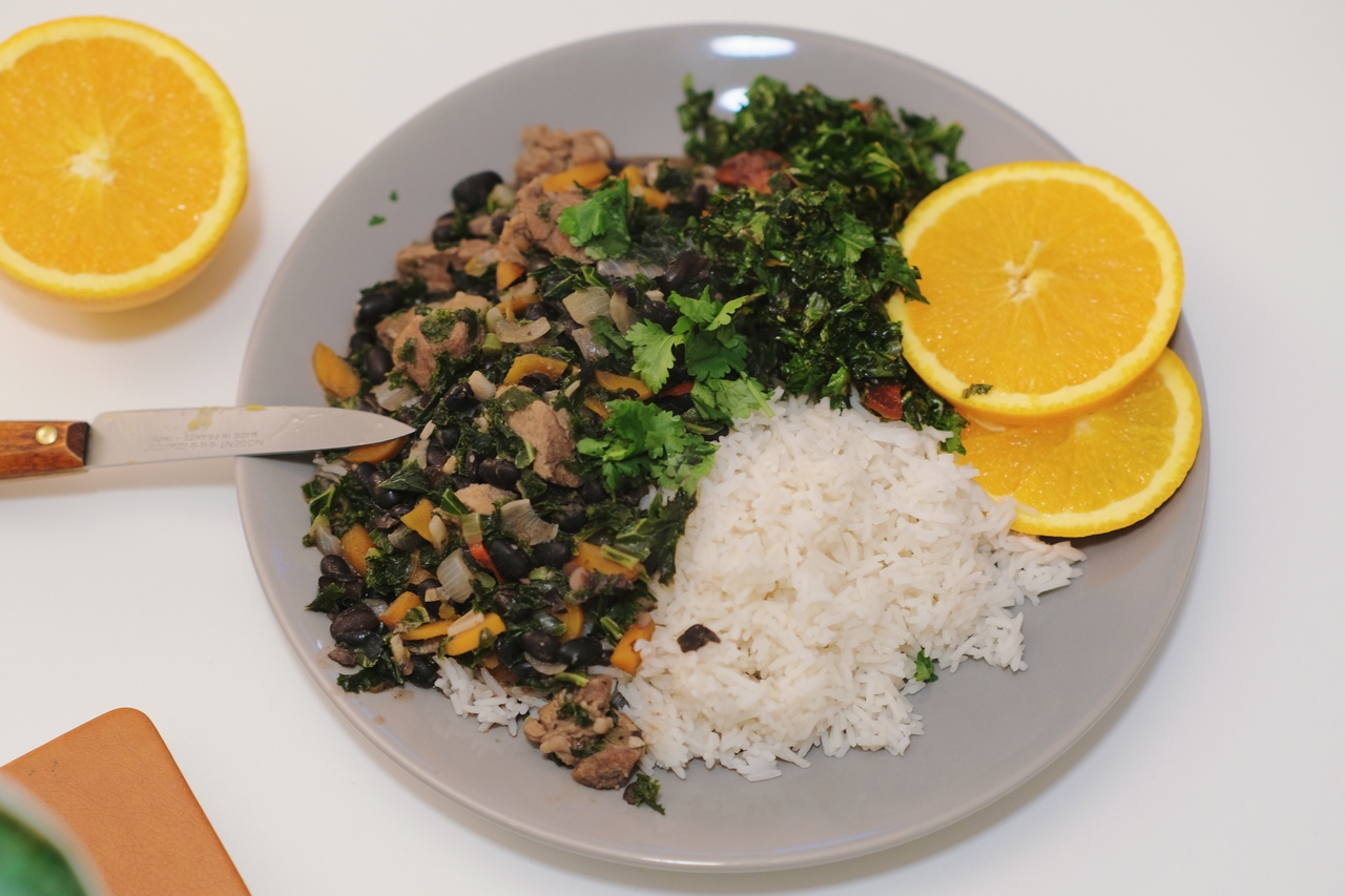 Brazilian bean and pork stew with kale, spiced sausage, rice, and orange, in my Amsterdam kitchen, 2021. (also, it is that time of the year again where there is no more daylight once I am starting dinner. sadface)