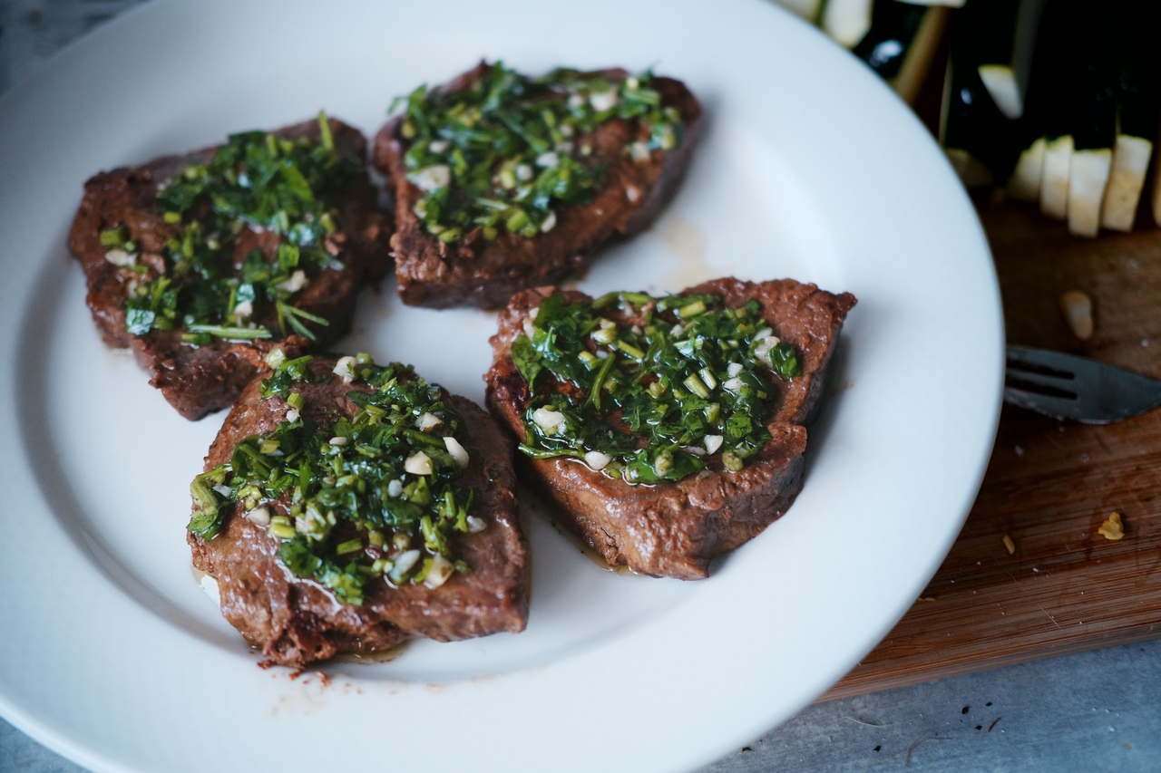 Grilled beef steaks topped with chimichurri, resting. In my father's kitchen, Tilburg, 2022.