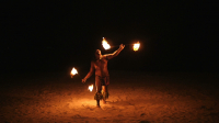 Bora Bora, slow motion shot of fire dancer on white sand by night