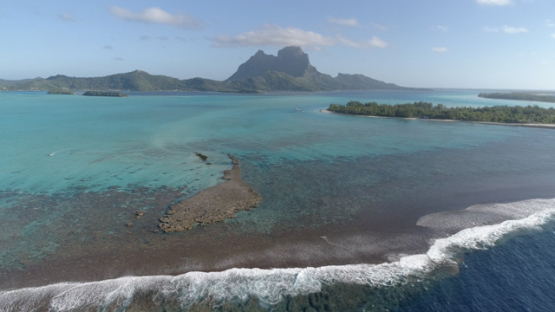 Aerial panoramic view of the island Bora Bora and reef, 4K UHD