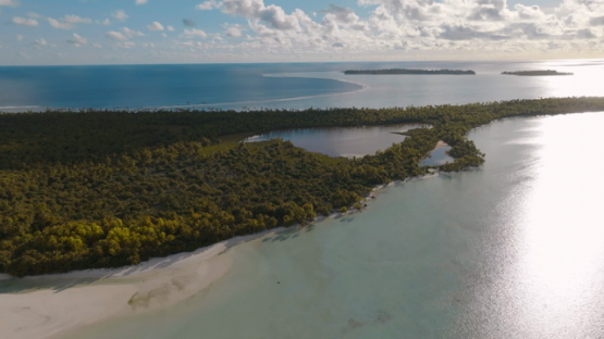 Aerial drone view of the atoll Tetiaroa, lagoon and islets and sunset, 4K UHD