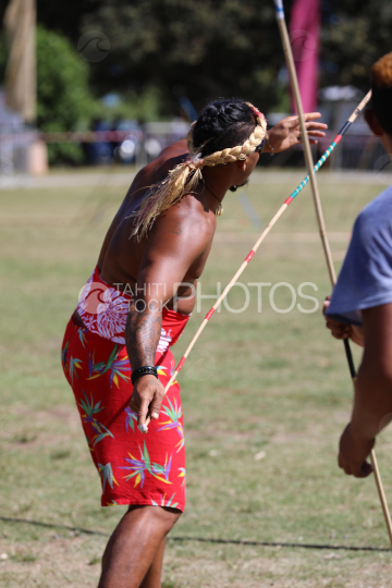 Tahiti, Polynesian man with red pareo, traditional javelin throwing competition, Tuaro Maohi, Polynesia