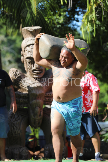 Tahiti, Polynesian Man lifting a heavy stone, Stone lifting competition, Tuaro Maohi, Polynesia