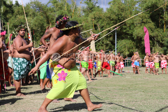 Tahiti, Polynesian man with green pareo, traditional javelin throwing competition, Tuaro Maohi, Polynesia