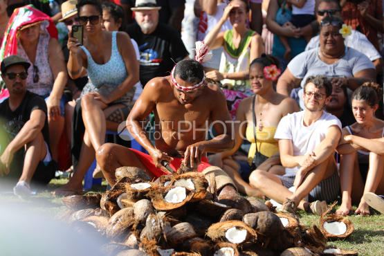 Tahiti, Polynesian man shelling coconuts, Tuaro Maohi Traditional Competition, Polynesia