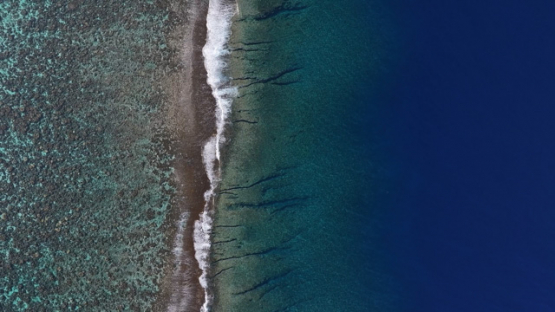 Aerial top down view of the barrier reef and shore break, Tetiaroa, 4K UHD