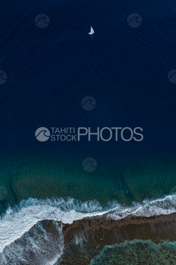 Drone top view, Sailing boat and coral reef, Tahiti, French Polynesia