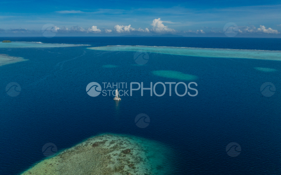 Raiatea, Sailing boat in the lagoon, French POlynesia, Aerial 