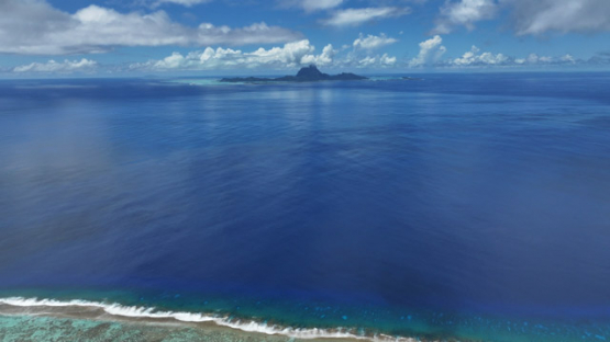 Bora Bora view from Tahaa, Drone Aerial Shot of Tahaa Lagoon with Mount Otemanu,Bora Bora, on the horizon, French Polynesia