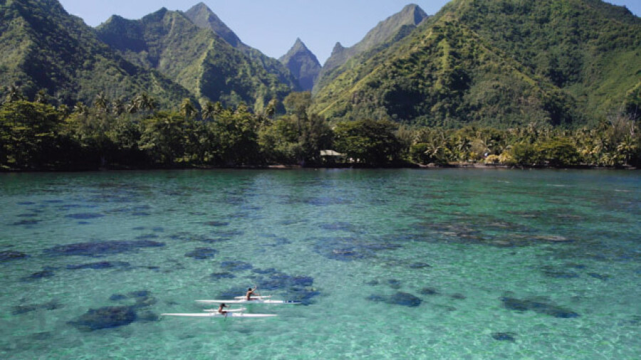 Va'a outrigger canoe in crystal lagoon